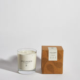 Boujie Unclouded luxury soy wax jar candle, front view with packaging, displayed in a clear glass jar with box, scented with rock salt and driftwood, styled with coastal-inspired elements.